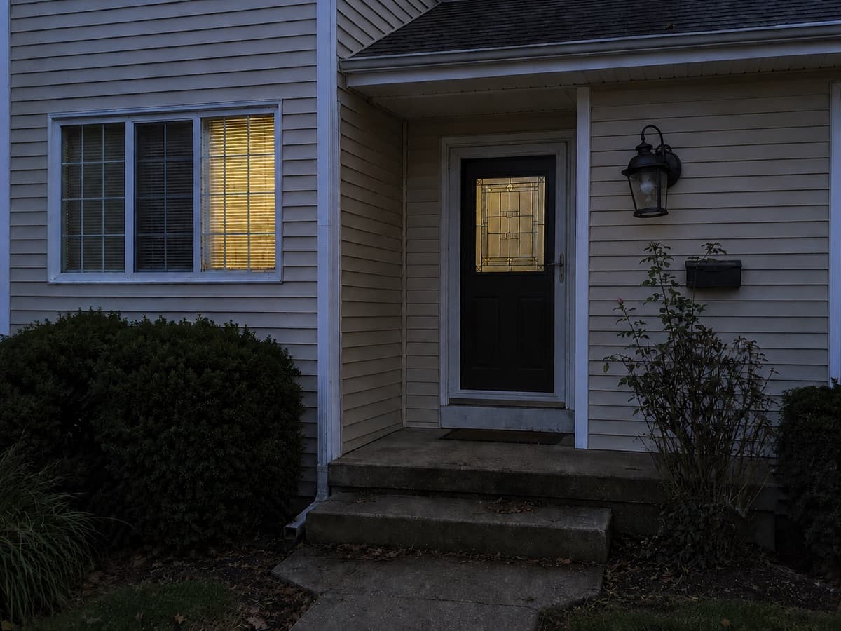Broken outdoor light creating a safety hazard