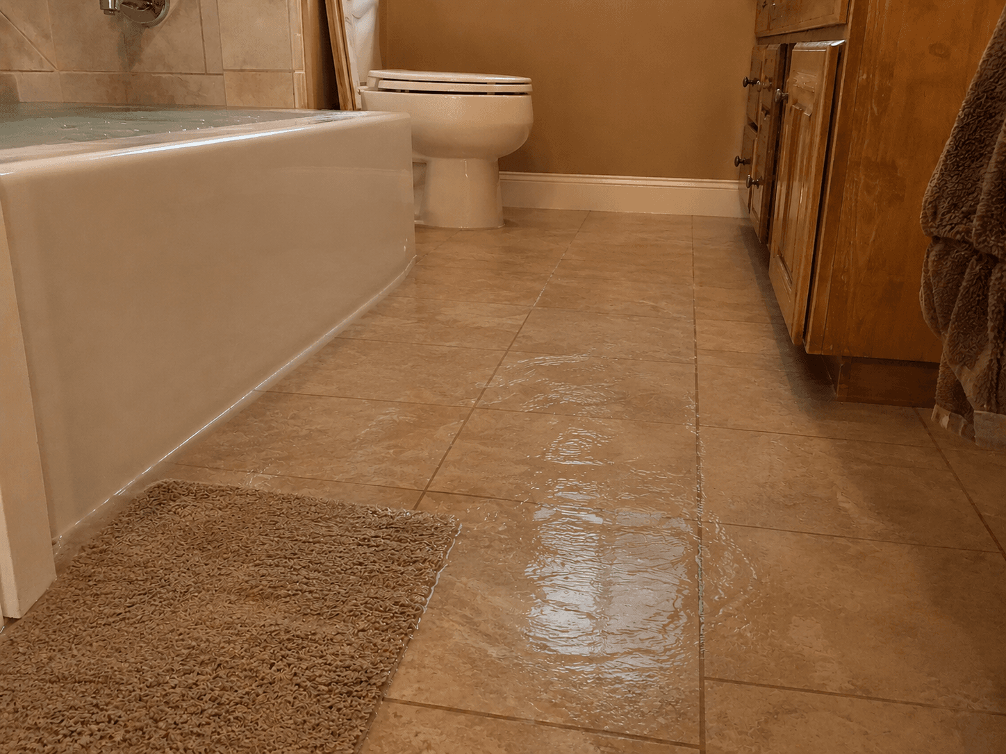Bathtub overflow creating a water and slip hazard