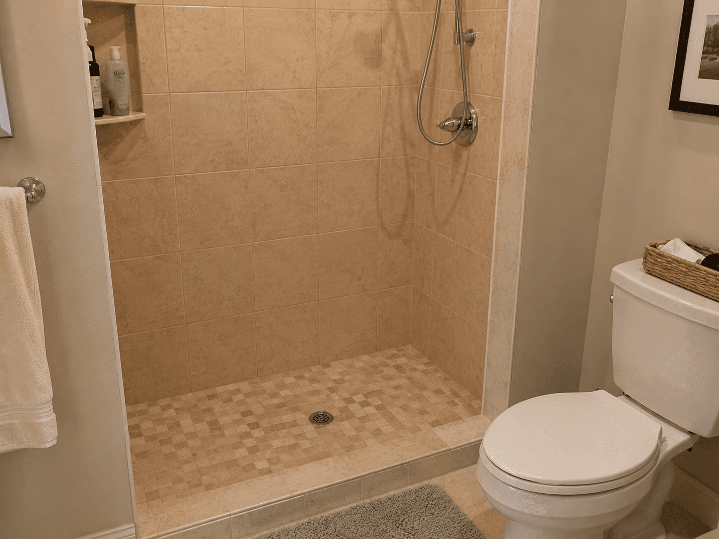 Shower with no bench or seat creating a fall risk