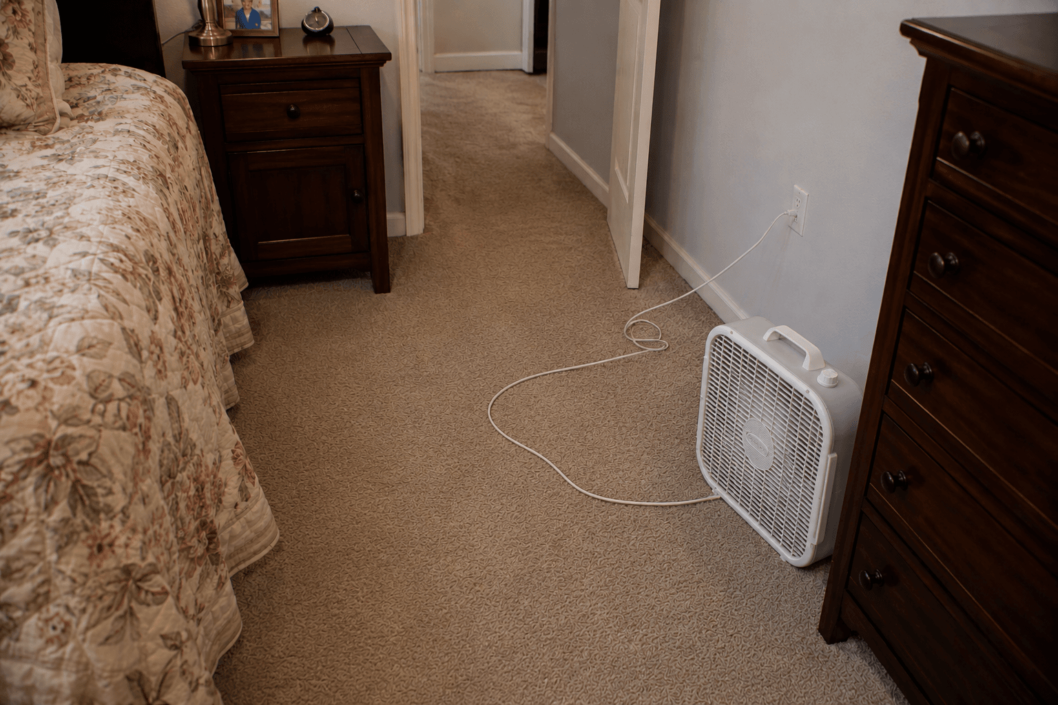 Electrical cord creating a trip hazard in the bedroom