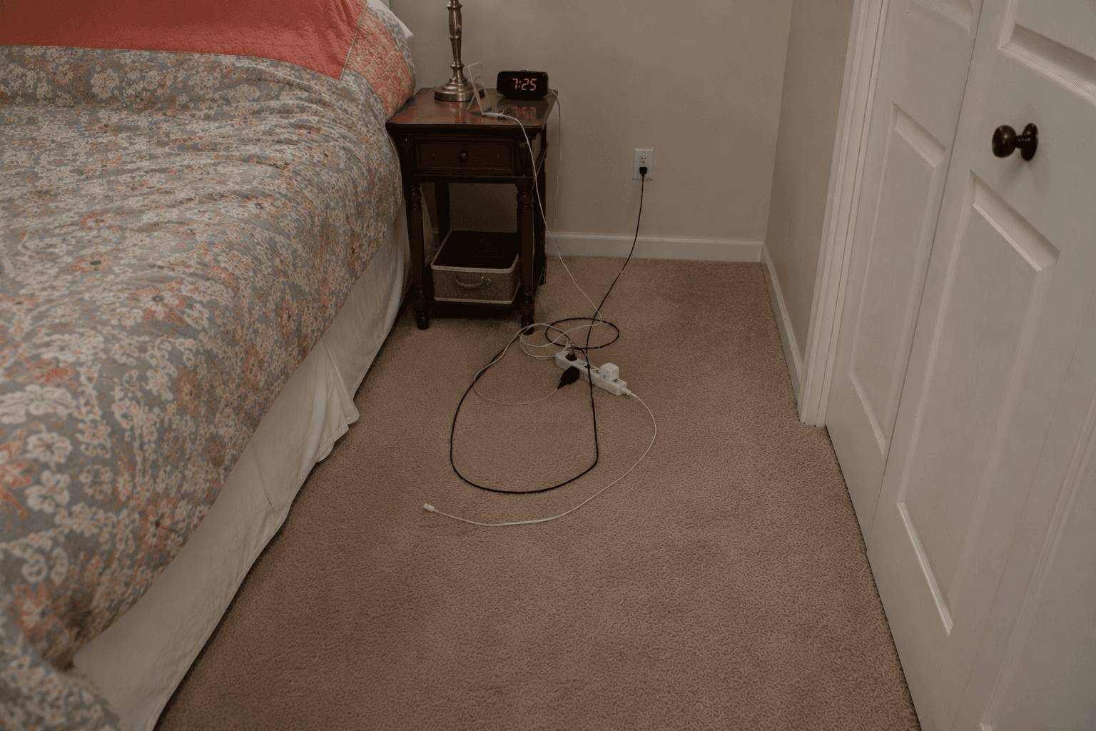 Multiple electrical cords creating hazards in the bedroom