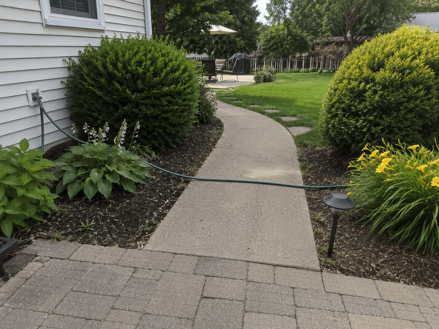 Garden hose creating a tripping hazard