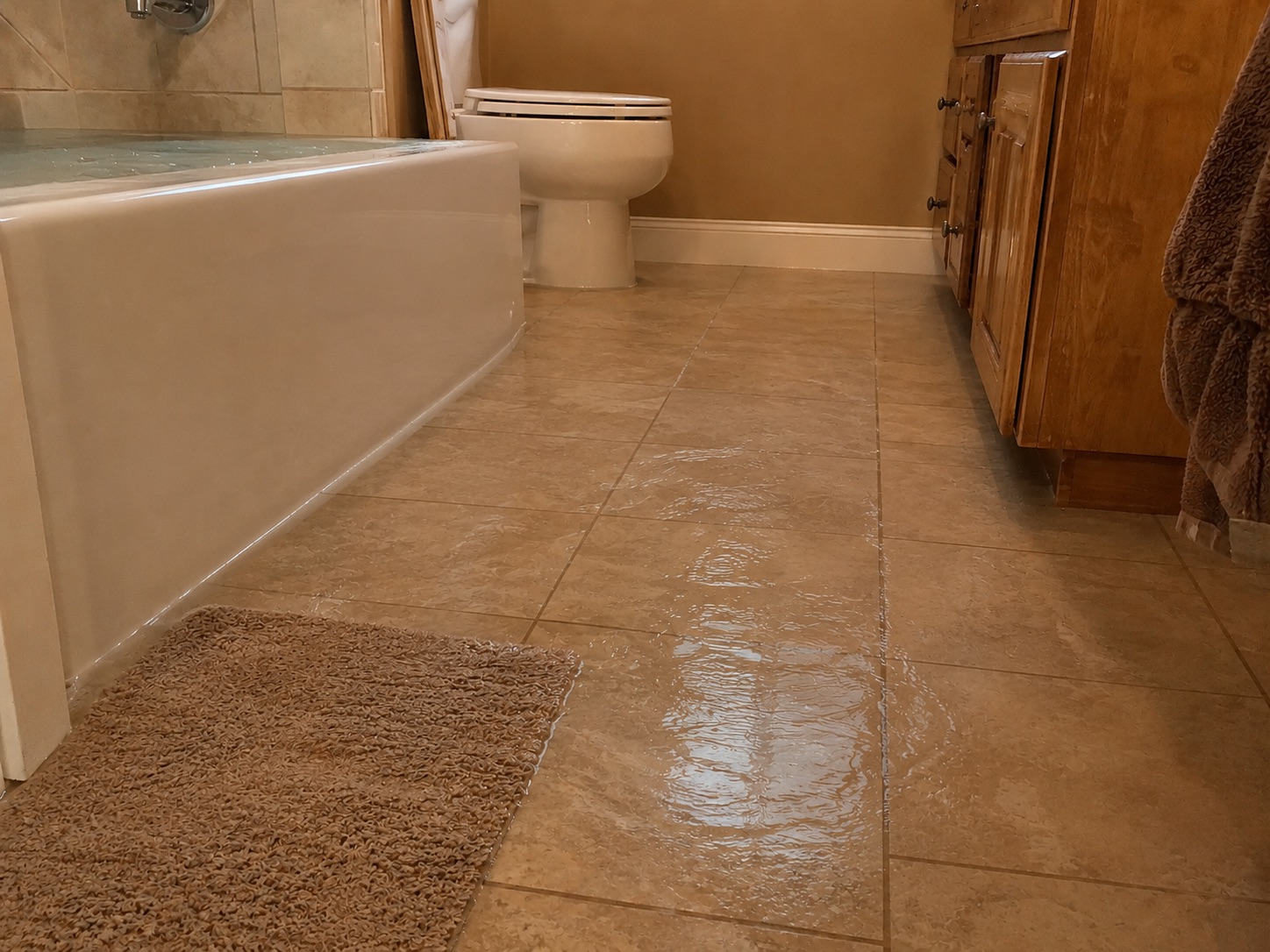Bathtub overflow creating a water and slip hazard