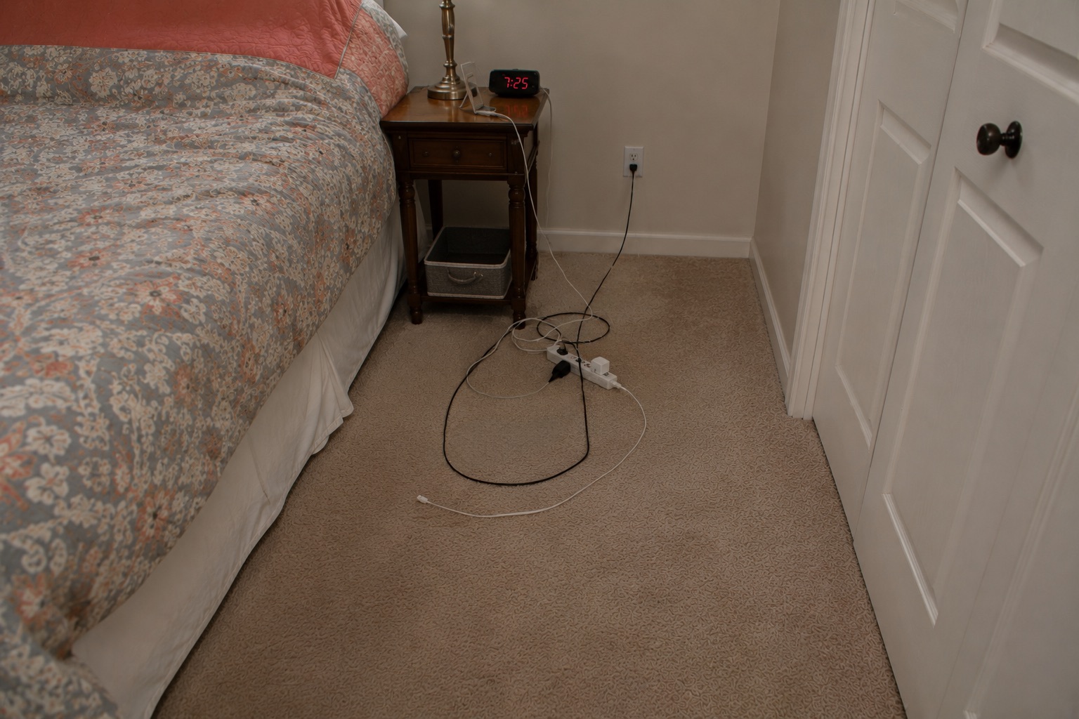 Multiple electrical cords creating hazards in the bedroom